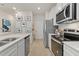 Modern kitchen features stainless steel appliances, a large sink, and white cabinets at 308 Navigator Ln, Mcdonough, GA 30253