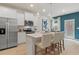 Modern eat-in kitchen featuring stainless steel appliances, white cabinets, and a stylish center island at 308 Navigator Ln, Mcdonough, GA 30253