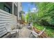 Backyard patio featuring multiple seating arrangements, privacy fence and lush landscaping at 428 Sycamore Dr, Decatur, GA 30030