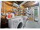 Functional basement laundry area with washer, dryer, shelving, and exposed utilities at 428 Sycamore Dr, Decatur, GA 30030