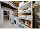 Functional basement laundry area with washer, dryer, shelving, and exposed utilities at 428 Sycamore Dr, Decatur, GA 30030