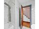 Modern bathroom with marble tiling, rainfall showerhead, and a glass door to the staircase at 428 Sycamore Dr, Decatur, GA 30030