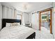 Bedroom featuring white tile floors, a full bed, and a sliding barn door to the kitchen at 428 Sycamore Dr, Decatur, GA 30030