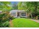 Charming home with a well-manicured lawn, stone accents, wood shutters, and a welcoming front porch at 428 Sycamore Dr, Decatur, GA 30030