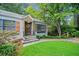 Well-maintained home with a stone accent wall, wood shutters, and a lush green lawn at 428 Sycamore Dr, Decatur, GA 30030