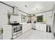 Modern kitchen with stainless steel oven, marble floor, and white cabinets and lots of natural light at 428 Sycamore Dr, Decatur, GA 30030