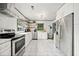 Spacious modern kitchen with stainless steel appliances, white cabinets, and marble floors at 428 Sycamore Dr, Decatur, GA 30030