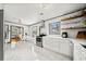 Bright modern kitchen with stainless steel appliances, marble floors, white cabinetry and dining nook at 428 Sycamore Dr, Decatur, GA 30030