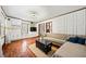 Stylish living room with hardwood floors, decorative wall paneling, and ample natural light at 428 Sycamore Dr, Decatur, GA 30030