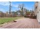 Spacious backyard deck perfect for entertaining with green grass, a wood fence, and privacy at 4962 Preswick Ne Ct, Marietta, GA 30066