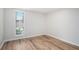 Bedroom featuring wood floors, a window with blinds, and neutral paint at 4962 Preswick Ne Ct, Marietta, GA 30066