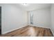 Bedroom featuring wood floors, neutral paint, a window with blinds, and a closet at 4962 Preswick Ne Ct, Marietta, GA 30066