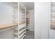 Walk-in closet with custom shelving, drawers and clothing racks at 4962 Preswick Ne Ct, Marietta, GA 30066