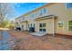 Exterior view of backyard patios and yellow siding at 6860 Robinson St, Lithonia, GA 30058