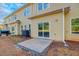 Backyard patio with sliding glass doors and yellow siding at 6860 Robinson St, Lithonia, GA 30058