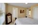 Bedroom with neutral walls, ceiling fan, white bedding and an antique mirror at 6860 Robinson St, Lithonia, GA 30058