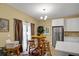 Kitchen nook with a wooden table and chairs adjacent to modern white cabinets and stainless steel fridge at 6860 Robinson St, Lithonia, GA 30058