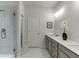 Bright bathroom featuring a glass enclosed shower and a double sink vanity with white countertop at 1236 Ainsworth Aly # 37, Sugar Hill, GA 30518