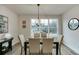 Dining room boasts natural light from a bright window and classic light fixture hanging above the table at 1236 Ainsworth Aly # 37, Sugar Hill, GA 30518