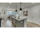 Modern kitchen island includes stone countertops, stainless steel sink and appliances, and an open view to the dining area at 1236 Ainsworth Aly # 37, Sugar Hill, GA 30518