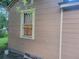 Exterior view of the home's siding and window, featuring decorative bars at 1767 Thomas St, Decatur, GA 30032