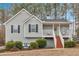 Charming gray home featuring a welcoming front porch and well-maintained landscaping at 182 Noah Dr, Rockmart, GA 30153