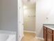 View into a bathroom area with brown cabinets, white trim, and a bathtub at 2890 Ridgeview Sw Dr, Atlanta, GA 30331