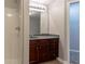 Bathroom with wood cabinet, grey countertop and shower with white tiles at 2890 Ridgeview Sw Dr, Atlanta, GA 30331