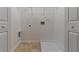 Laundry room featuring tile flooring, a shelf, washer hookups, and white trim at 2890 Ridgeview Sw Dr, Atlanta, GA 30331