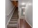 Carpeted stairs with wooden handrail lead to upper levels of the home at 2890 Ridgeview Sw Dr, Atlanta, GA 30331