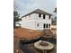 New construction showing the building phase with black weather resistant barrier installed and a front door at 4862 Campbell Dr, Atlanta, GA 30349