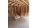 Interior view of a framed house under construction showcasing wooden beams, studs, and a staircase at 4862 Campbell Dr, Atlanta, GA 30349