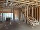 Interior view of a framed house under construction showcasing wooden beams, studs, and a staircase at 4862 Campbell Dr, Atlanta, GA 30349