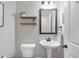 Bathroom showcasing a pedestal sink, framed mirror, and modern lighting fixtures at 117 Pacific Ave, Sharpsburg, GA 30277