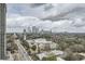 Sweeping aerial view of a city with lush green trees and the skyline on a cloudy day at 2626 Peachtree Nw Rd # 804, Atlanta, GA 30305