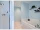 Bright bathroom showcasing a tub with white tile surround and walk-in shower at 2626 Peachtree Nw Rd # 804, Atlanta, GA 30305