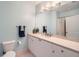 Bright bathroom featuring white cabinets, a neutral countertop, large mirror and modern lighting at 2626 Peachtree Nw Rd # 804, Atlanta, GA 30305