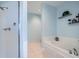 Bathroom with tile floors, tiled walk-in shower and soaking tub with light blue walls at 2626 Peachtree Nw Rd # 804, Atlanta, GA 30305