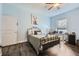 Bedroom with a wrought iron bed frame, wood floors, a ceiling fan, and a window with blinds at 2626 Peachtree Nw Rd # 804, Atlanta, GA 30305