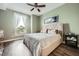 Cozy bedroom with wood floors, ceiling fan, and large window that provides natural light and a calm, relaxing vibe at 2626 Peachtree Nw Rd # 804, Atlanta, GA 30305