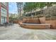 Charming courtyard with a tiered fountain, stone patio, and seating area surrounded by lush greenery at 2626 Peachtree Nw Rd # 804, Atlanta, GA 30305