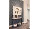 Hallway with wood floors, patterned wallpaper, modern table, and painting at 2626 Peachtree Nw Rd # 804, Atlanta, GA 30305