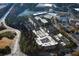 An aerial view of a community surrounded by trees, roadways and a nearby lake at 5003 Hartwell Pl, Alpharetta, GA 30009