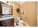 Cozy bathroom features decorative mirror, granite countertop and tiled floors at 6995 Polo Fields Pkwy, Cumming, GA 30040