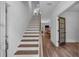 Bright entryway featuring a staircase with wood treads and elegant wood-look floors leading to an open living area at 129 Old Alabama Se Rd, Emerson, GA 30137