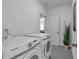 Bright laundry room with modern, white Samsung washer and dryer units at 129 Old Alabama Se Rd, Emerson, GA 30137