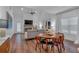 Open-concept living and dining area with wood floors, a fireplace, and plenty of natural light at 129 Old Alabama Se Rd, Emerson, GA 30137