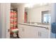 Bright bathroom features granite countertop, double sinks, and colorful shower curtain at 2882 Cadence Walk Rd, Atlanta, GA 30360