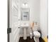 Powder room featuring pedestal sink, modern fixtures and convenient location at 2882 Cadence Walk Rd, Atlanta, GA 30360