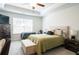 Comfortable bedroom features neutral tones, tray ceiling and a large window at 2882 Cadence Walk Rd, Atlanta, GA 30360